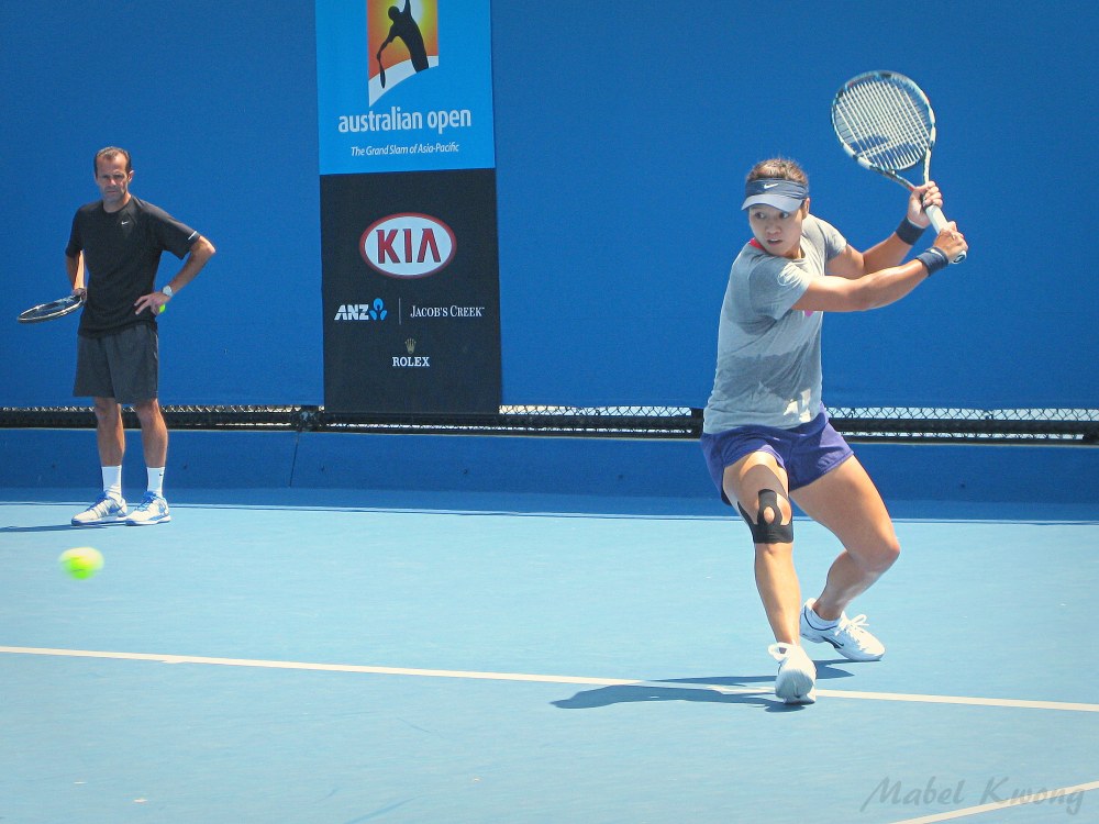 Li Na keeps an eye on whizzing tennis balls during Australian Open tennis practice | Weekly Photo Challenge: Blur.
